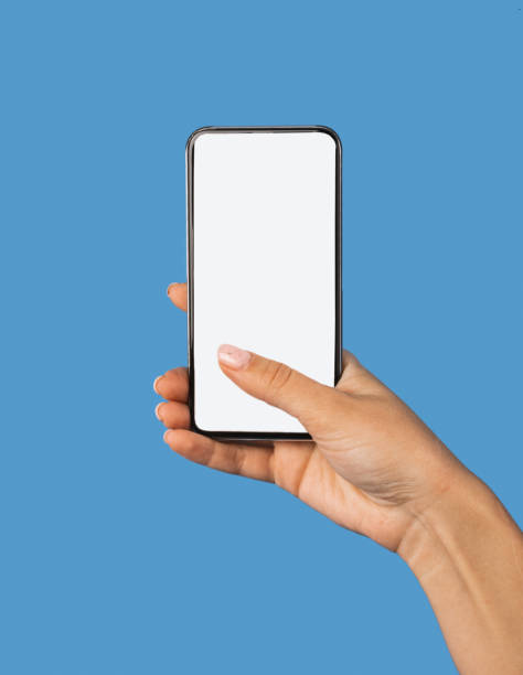 istock Female Hand Holding Phone With Empty Screen Over Blue Background 1297772163