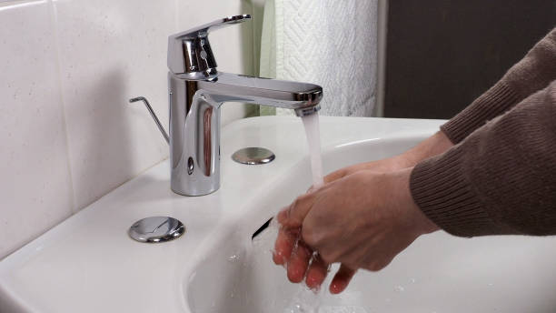 istock Unrecognisable person washing hands 1297772229