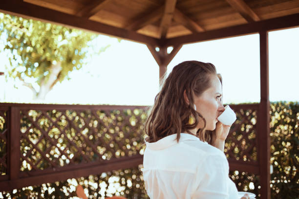 istock relaxed stylish woman in white shirt 1297773262