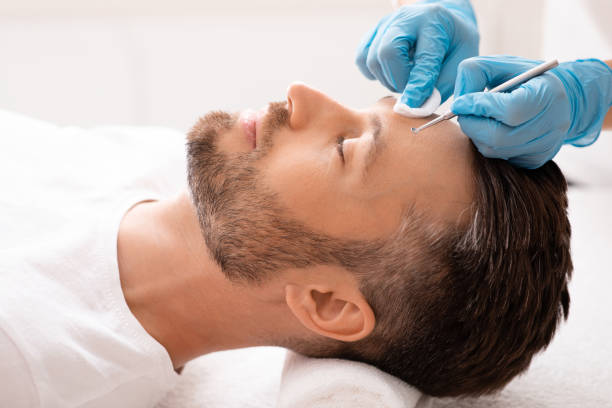 istock Face cleaning procedure for middle-aged handsome man 1297773369