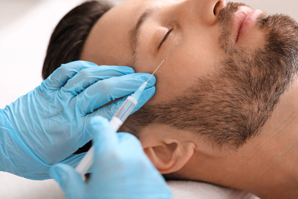 istock Man getting beauty injection against eye wrinkles 1297773396