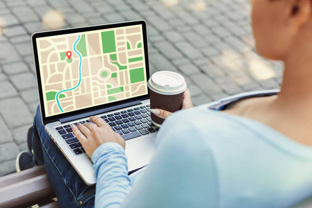 istock Online Maps. Woman Using Laptop With Opened GPS Satellite Navigation Website Outdoors 1297776340