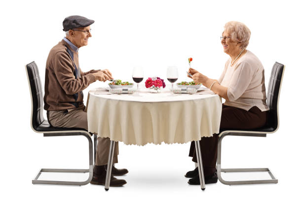 idoso e mulher com salada e vinho em uma mesa - table restaurant chair people - fotografias e filmes do acervo