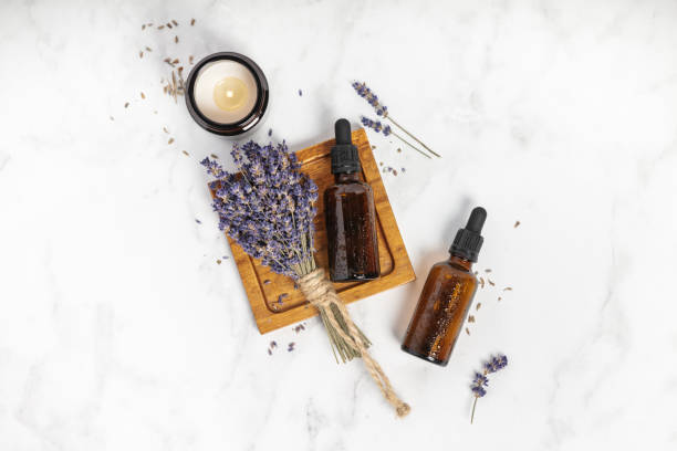 istock Flat lay composition with lavender flowers and natural cosmetic on white marble background 1297777919