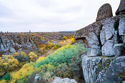 Aktovsky Canyon, Ukraine. Autumn trees and large stone boulders around