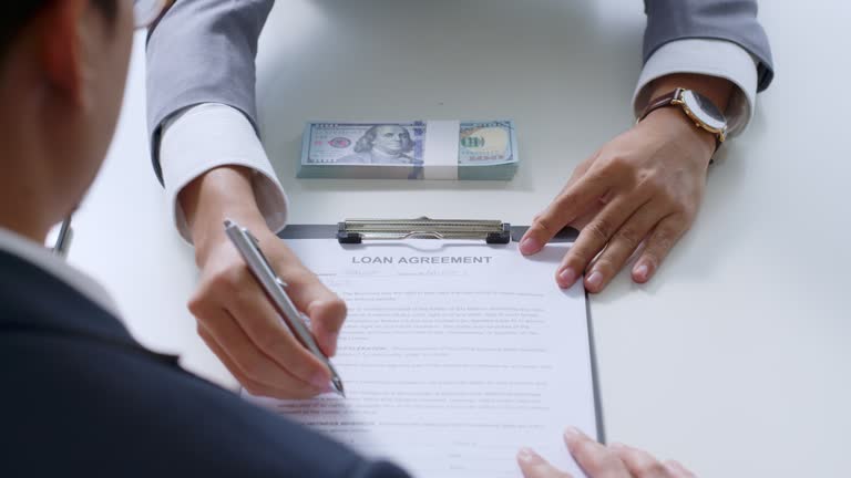 Businessman sign on money loan agreement contract to banker, loan and credit financial lease concept