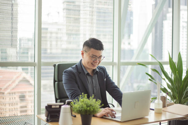 istock Asian Chinese businessman working in his workspace. 1297780390