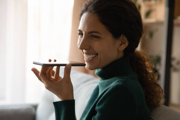 istock Smiling woman talk on loudspeaker on cellphone 1297781532