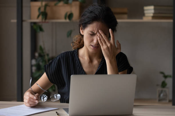 istock Unwell woman suffer from migraine overwhelmed with computer work 1297781587