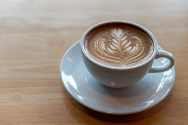istock Latte art coffee cup on wooden table 1297783047