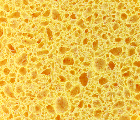 Sponge background. Cellular background.Yellow sponge for washing isolated. Porous material.