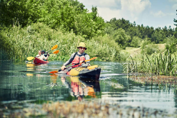 istock Happy best friends having fun on a kayaks. Kayaking on the river. 1297785500