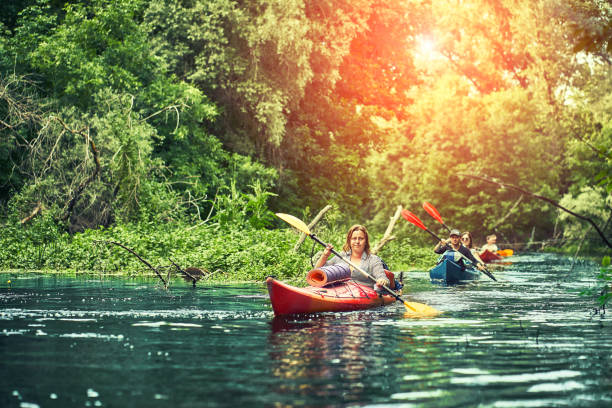 istock Happy best friends having fun on a kayaks. Kayaking on the river. 1297785505