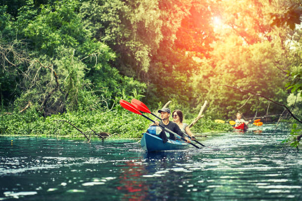 istock Happy best friends having fun on a kayaks. Kayaking on the river. 1297785510