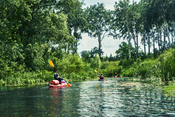 istock Happy best friends having fun on a kayaks. Kayaking on the river. 1297785519