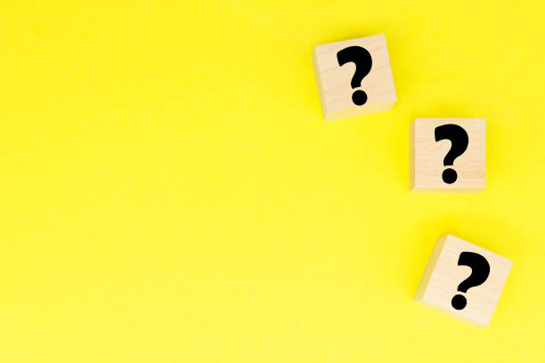 istock Wooden cube shape with sign question mark symbol . FAQ 1297786225