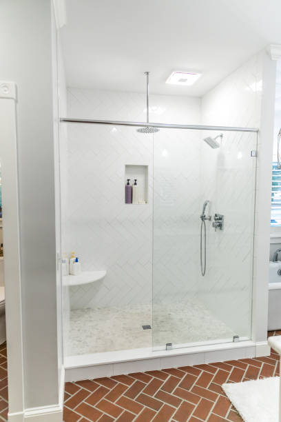 istock Large white renovated master bathroom with red brick floors 1297788448