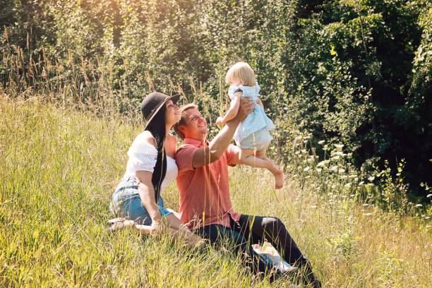 istock Family of Three Outside 1297788761