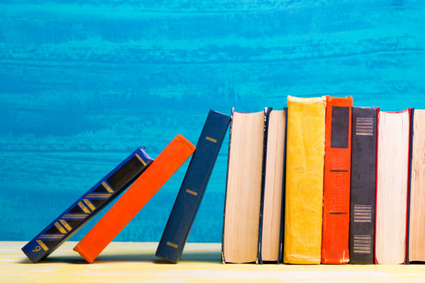 istock Books on wooden desk table and abstract background. Education background. Copy Space. Back to school. 1297789278