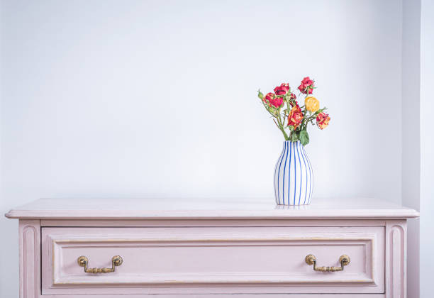 Soft Ivory, Pink & Yellow Country Garden Roses Arranged in a Vintage Crystal Vase with a Neutral Background