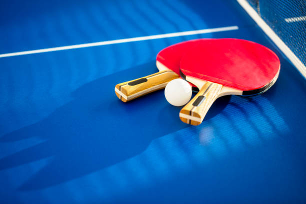 istock Table tennis or ping pong bat and ball background 1297792299