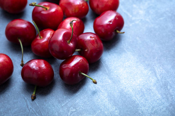 istock Ripe sweet cherry spread on a blue background. seen from above. Free space for edits. 1297792758