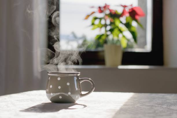 Cup of hot tea on the table, cozy home interior background