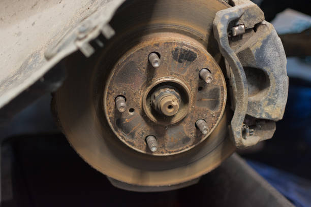 istock close-up of a car brake disc with brake calipers, rusty dirty, requiring replacement. Horizontal photo. soft focus, selective focus 1297794864