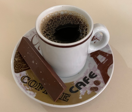 Coffee with a chocolate bar