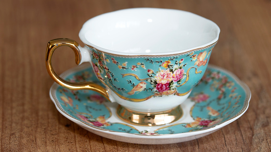 Empty vintage blue teacup and saucer with a teabag