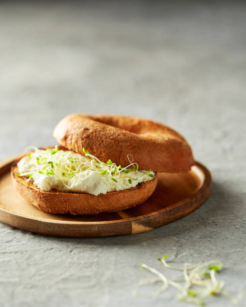 istock Bagel and Cream Cheese with Sprouts 1297795325