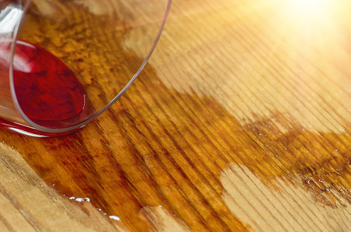 Spilled glass of wine on a wooden surface