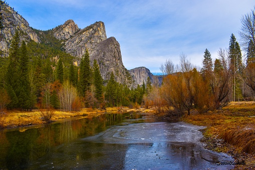Gorgeous Yosemite National Park valley view of Three Brothers mountains with river flowing below