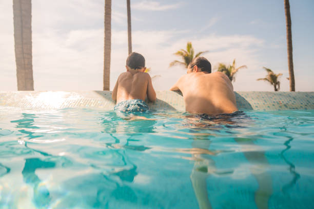 istock Father and son enjoying in the swimming pool 1297796664