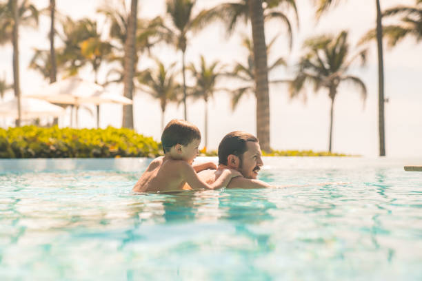 istock Father and son enjoying in the swimming pool 1297796779