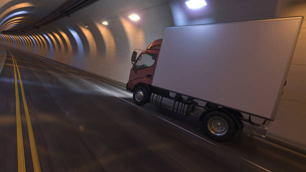 istock Side View of a Box Truck Moving Inside an Empty Illuminated Tunnel 1297798195