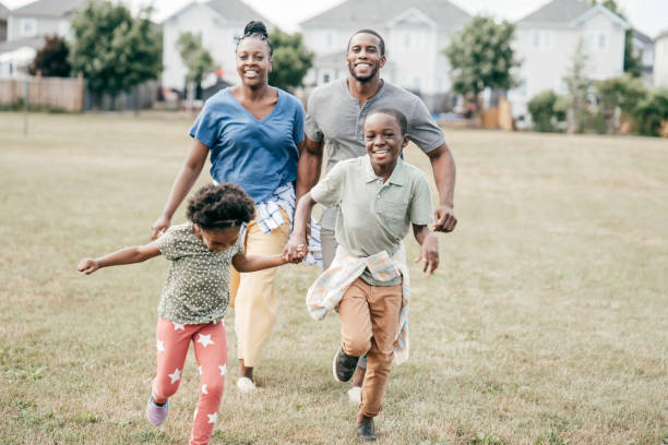 istock Happy family running through a field 1297798292