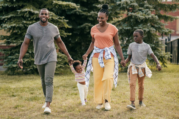 istock Family walking together while holding hands outside 1297798308