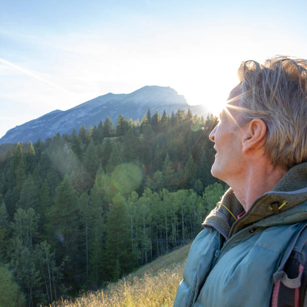 istock Male hiker walks along forested trail at sunrise 1297800072