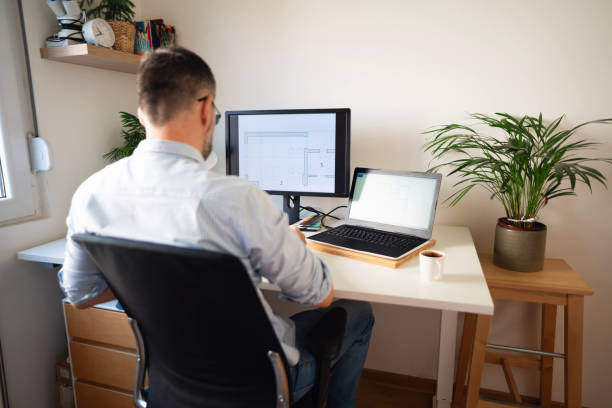 istock Unrecognizable man working at his desk at his home office 1297800771