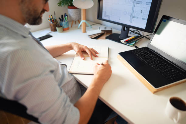 istock Close-up of a man's hands while working at his home office 1297800785