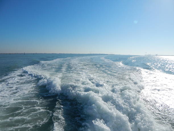 istock Seawater with sea foam behind a boat 1297801865
