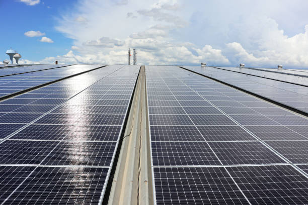 istock Solar PV System on Industry Roof with Cloudy Sky 1297803637
