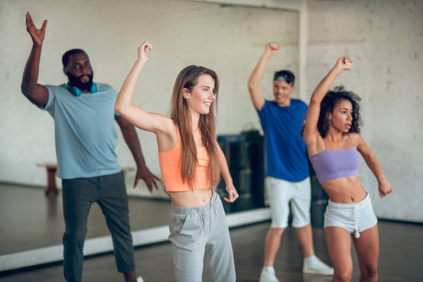 istock Group of young people dancing in studio 1297804539