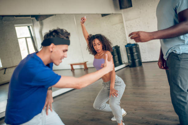 istock Girl with guy dancing and coach 1297804585