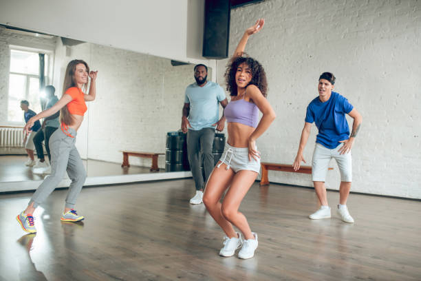 istock Group of young people engaged in dance studio 1297804587