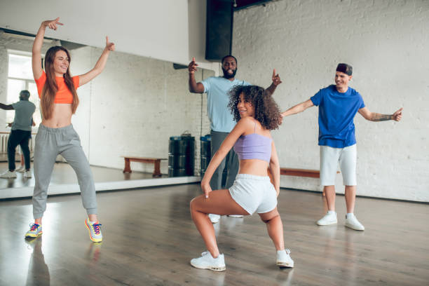 istock Group of young people and coach in dance hall 1297804599