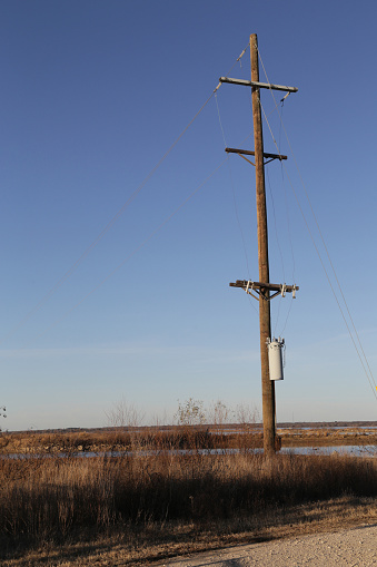 A lone, Wooden Utility pole in field, Texas, USA