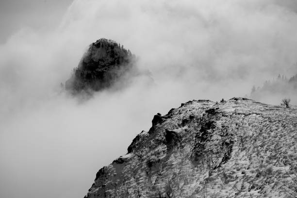 istock Mountain tops breaking through fog and clouds in winter 1297804918