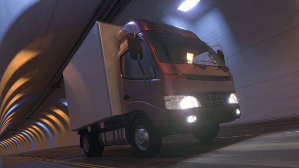 istock Low Angle View of a Box Truck Moving Inside an Illuminated Tunnel 1297805174